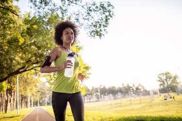 Young woman running in a public park